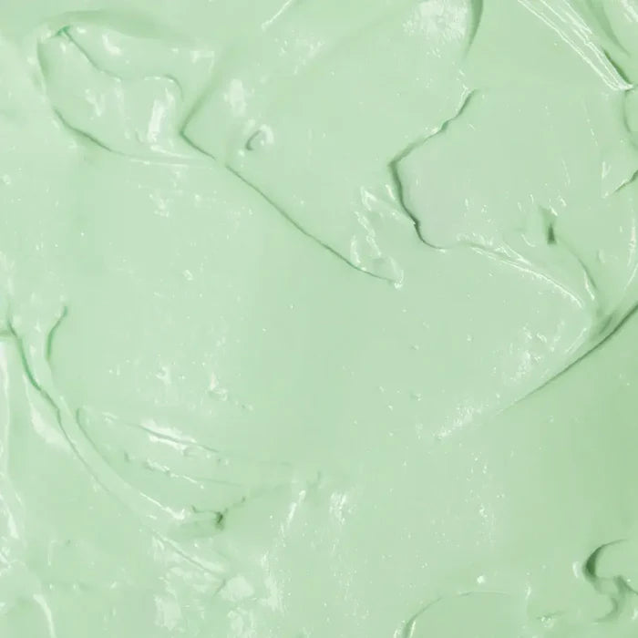 Textura do produto de creme para mãos FPS 60 da Ollie de cor esverdeada.